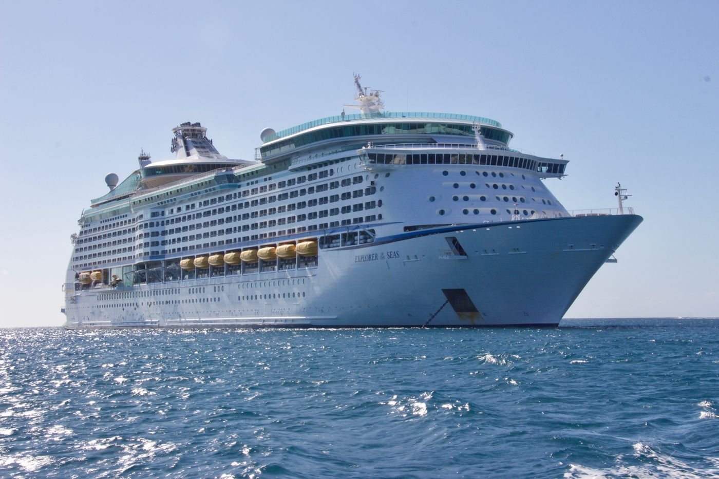 White cruise ship sailing on open blue seas